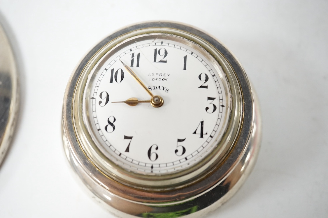 A George V Asprey & Co silver mounted brass cased timepiece, with Arabic dial and 8-day movement, the mount hallmarked for London, 1911, base diameter 72mm, together with a George V silver mounted capstan inkwell. Condit